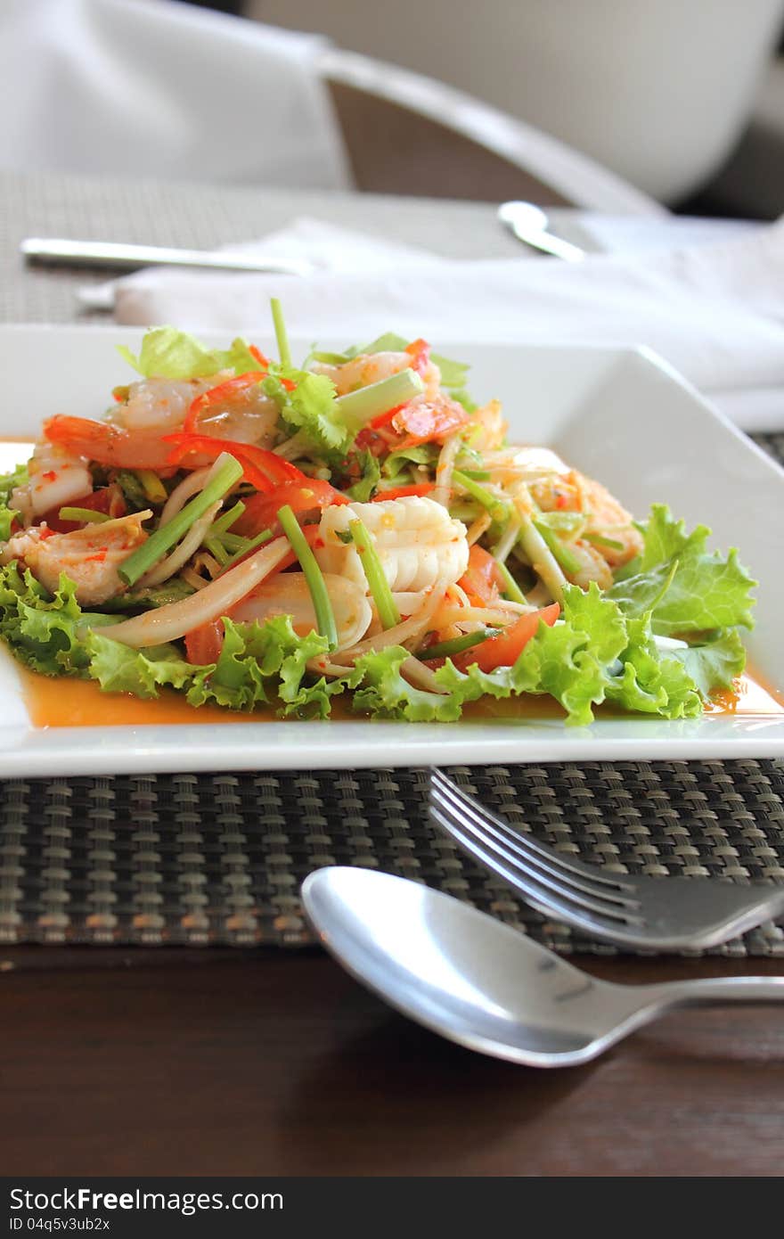 Seafood salad in the white plate rectangle. Seafood salad in the white plate rectangle