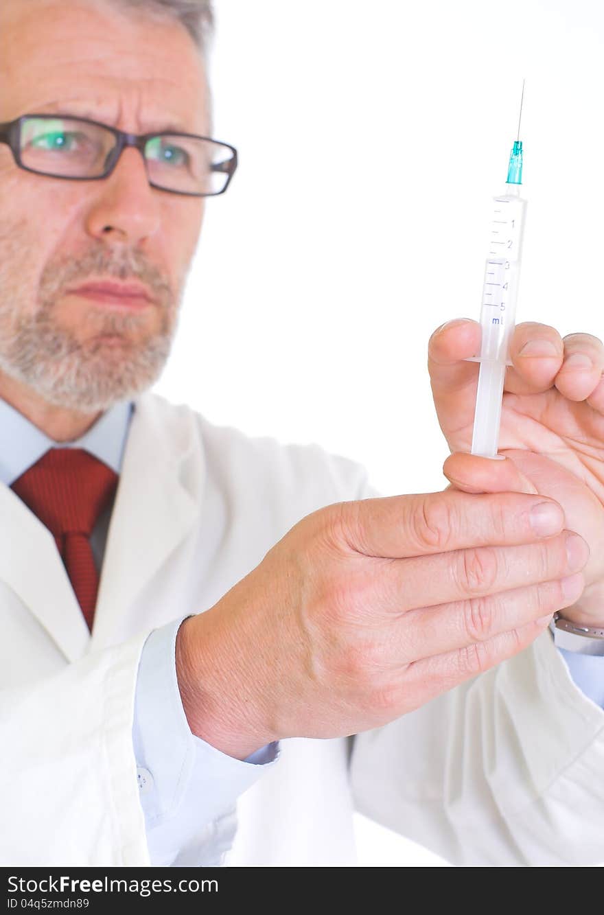 Image presents a doctor in white coat, getting ready for vaccination – he holds a syringe full of vaccine. Background white.