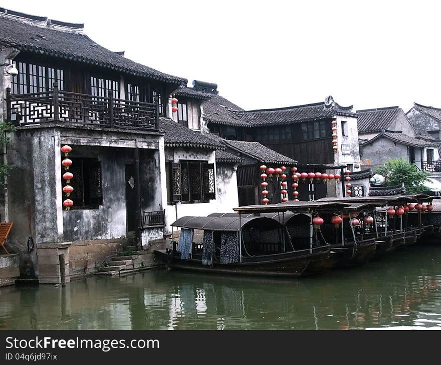 Xitang is level,densely distributed with rivers and has a very quiet natural environment.9 rivers converge in this town,dividing it into 8 sections,but many bridges link this water town together(anciently called as “nine dragon old pearl”and“wind from 8 sides”).Inside the town,there are many well-preserved architectural groups constructed during the Ming and Qing dynasties,which boast a higher artistry and study value,thus being highlighted by the experts at home and abroad studying antique buildings.Through a bird's-eye view of the whole town,green waves ripple everywhere and every family resides near water. In the morning,water flows beneath bridges,thin mist is like silk,pinkish walls on both banks stand tall and erect and tiled houses are reflected inversely in the water.In the evening,the setting sun shines slantwise,songs come from fishing boats,lamps flicker and the fragrance of wine drifts.The whole old town is like a poem and a picture.In this town,people will feel that they are seemingly in an earthly paradise.It is hard to know that people exist in the picture or picture exists in the heart of people.