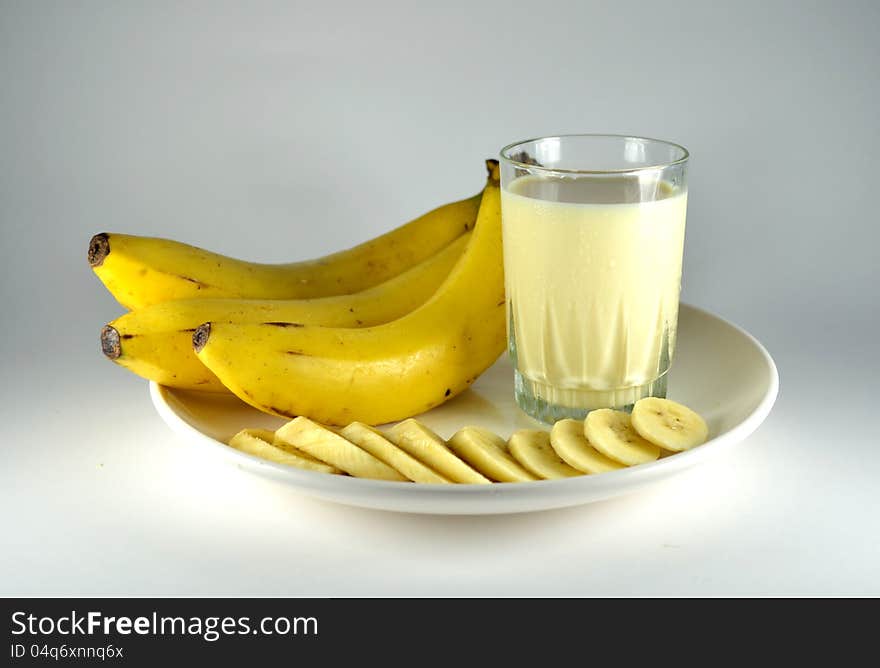 Big and long banana, pieces of banana and banana flavour milk