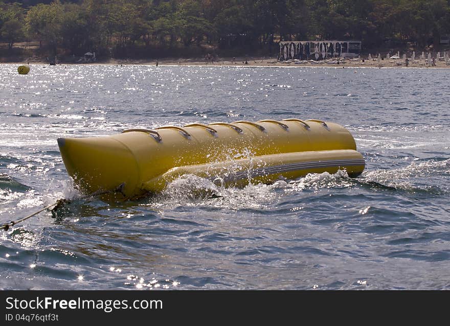 Yellow banana boat in a blue sea. Yellow banana boat in a blue sea.