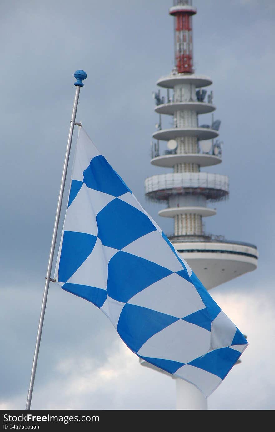 White-blue-checkered-flag bayern as symbol of october fixed and globalization of media communications by means of television transmission. White-blue-checkered-flag bayern as symbol of october fixed and globalization of media communications by means of television transmission