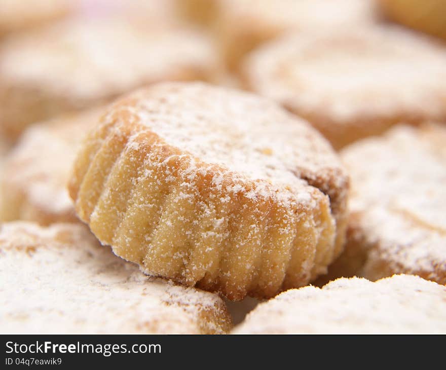 Cupcakes with icing sugar, in a pile, macro