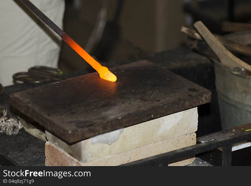 A hot glass drop being turned into a decoration in a small glass manufacture in old Prague, Czech Republic