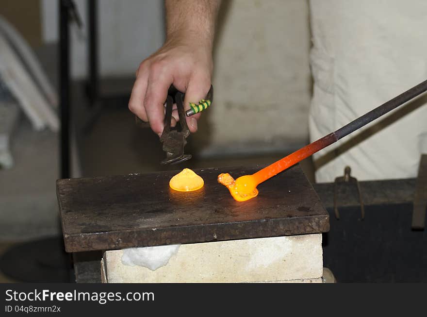 A hot glass drop being turned into a glass decoration in a small glass factory in Prague, Czech Republic