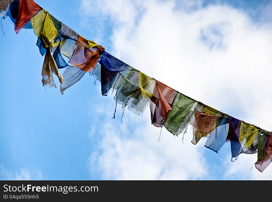 Buddhist flags against a blue sky