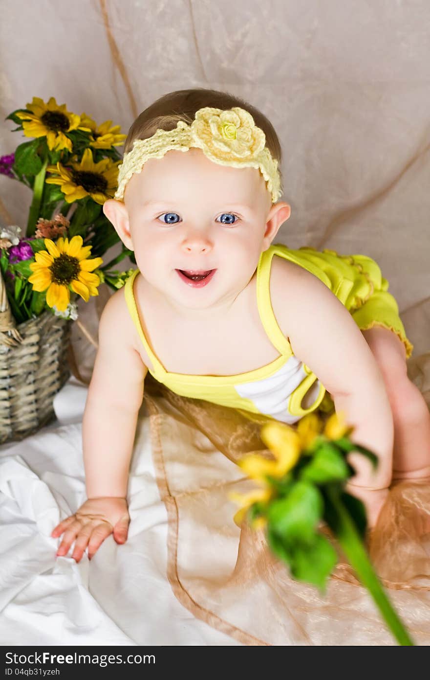 Baby is looking interested and try to reach the flower. Baby is looking interested and try to reach the flower