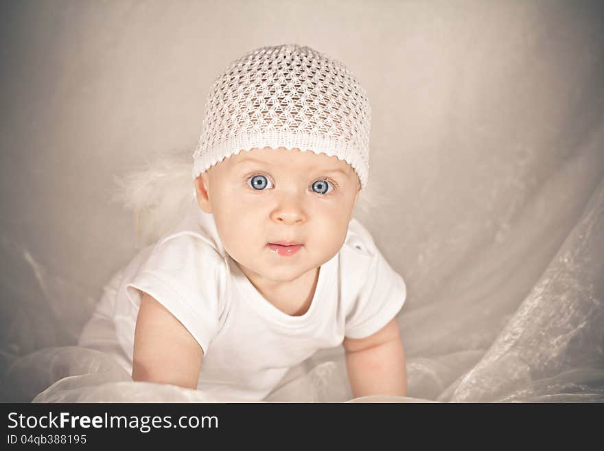 Baby with big blue eyes. Soft colors