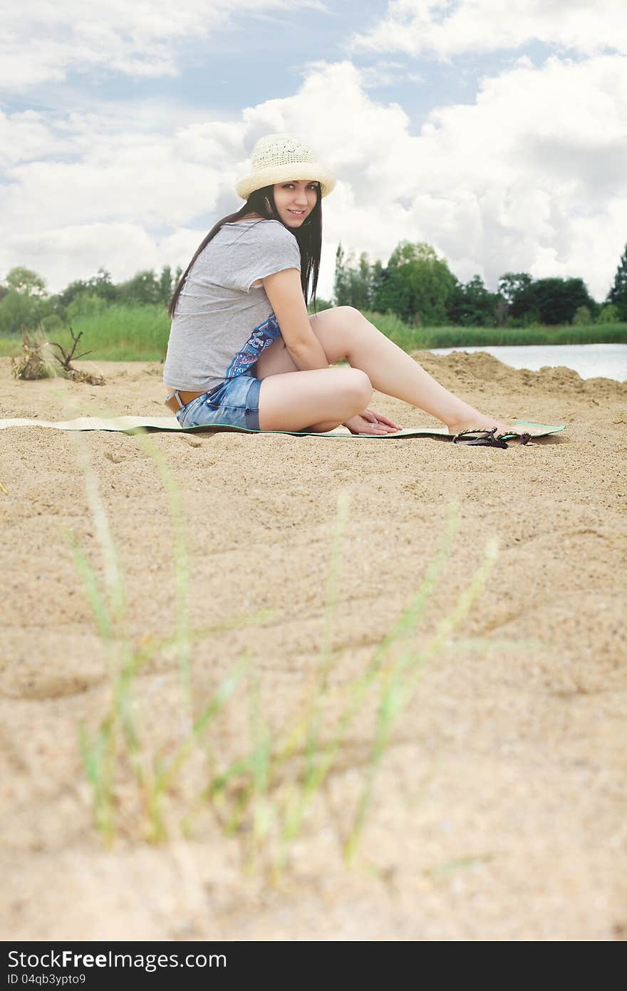 Woman near the lake on the beach. Woman near the lake on the beach