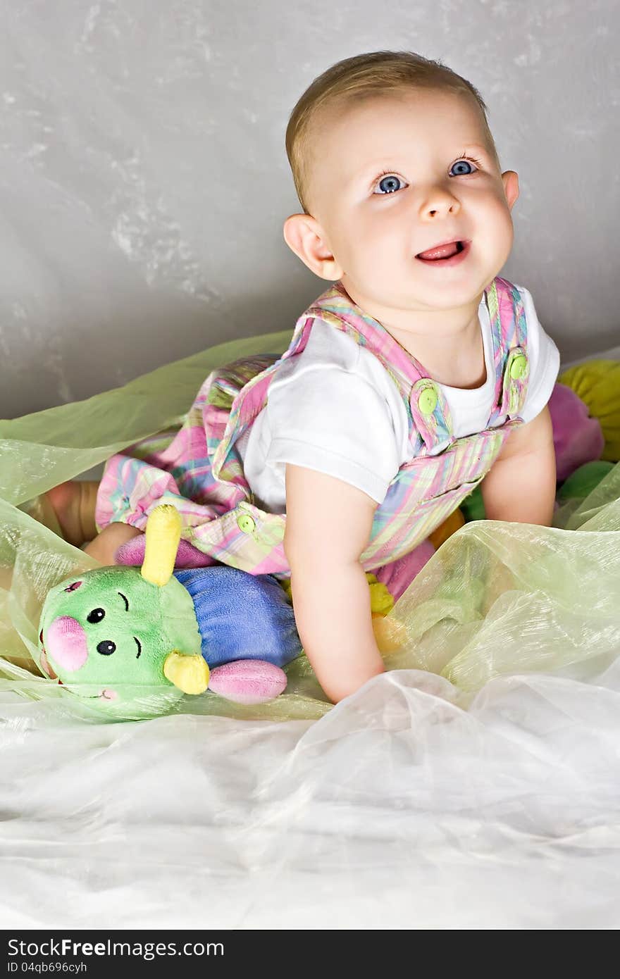 Crawling baby girl and her toy