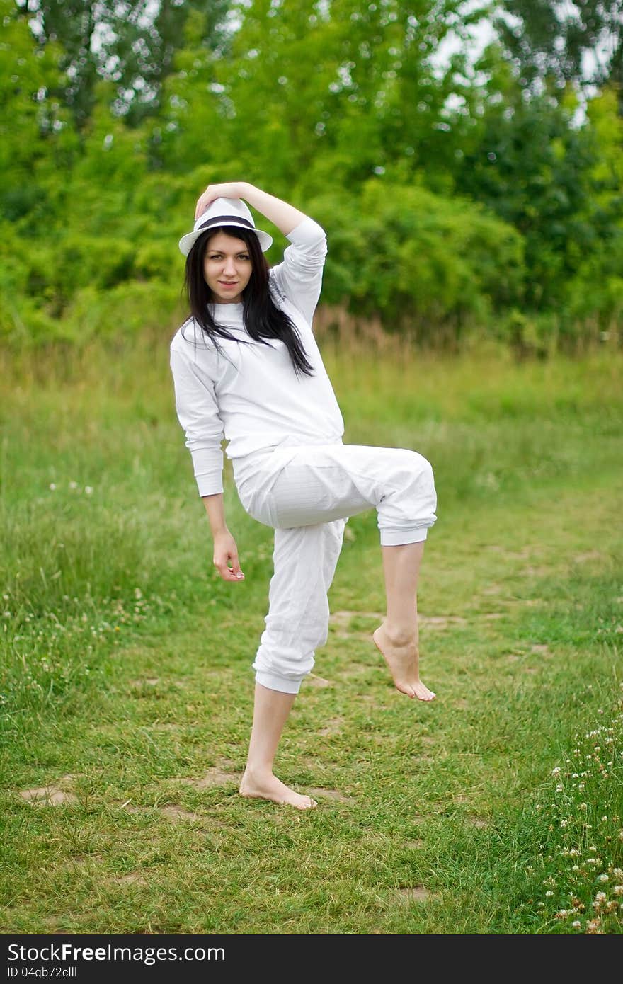 A young woman posing on the path throw meadows. A young woman posing on the path throw meadows