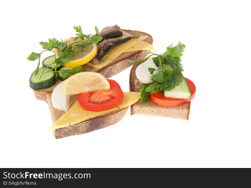 Three bits rye-bread with canned fish, tomato and cheese. Isolated on a white background. Three bits rye-bread with canned fish, tomato and cheese. Isolated on a white background.