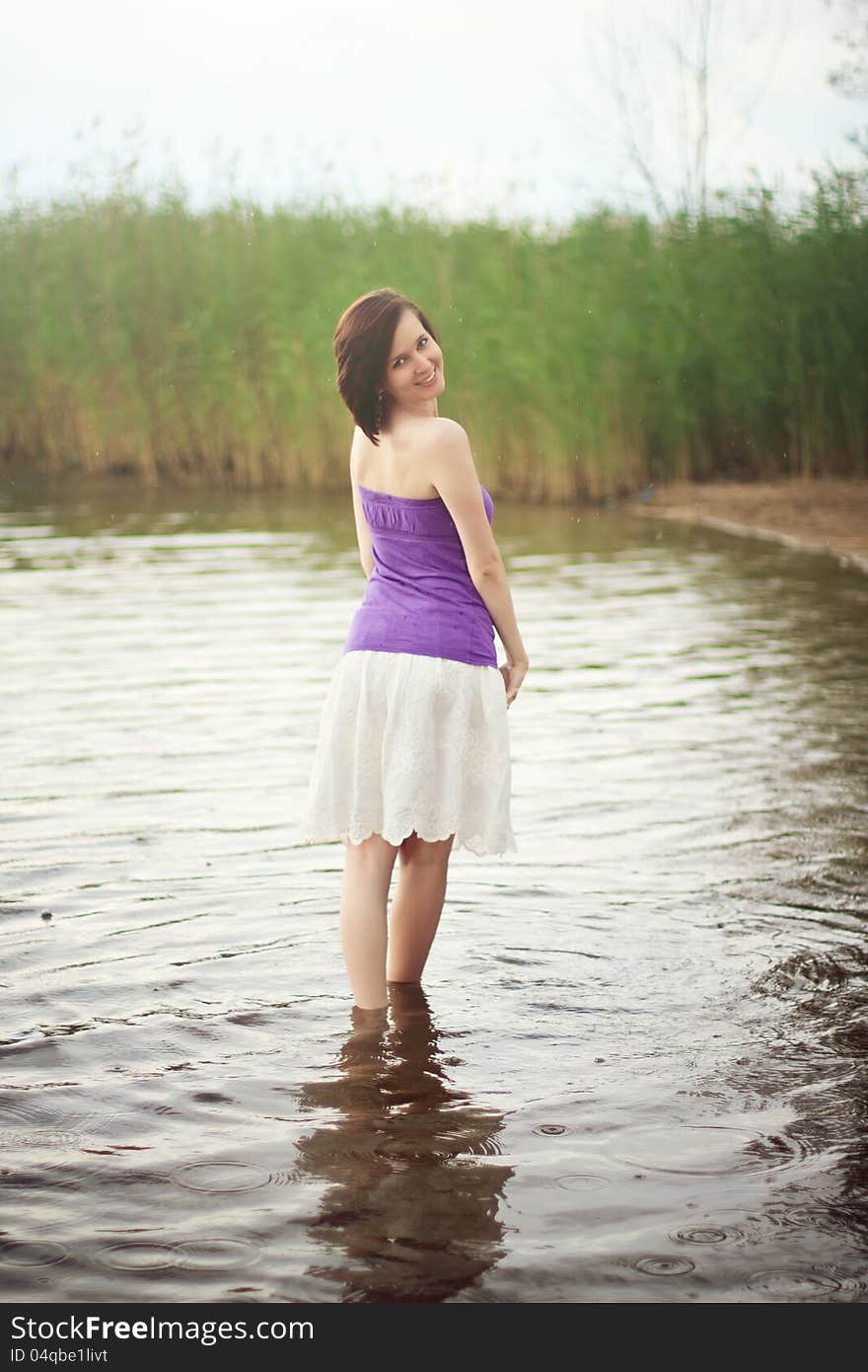 Young woman wading out of fresh water lake. Young woman wading out of fresh water lake