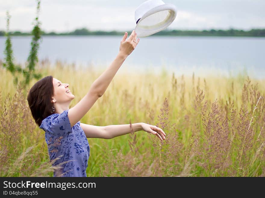 Young woman throwing up the hat