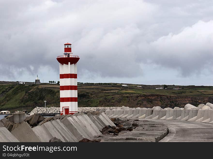 Small lighthouse maring the entrance of Praia da Vitória (Azores) harbour. Small lighthouse maring the entrance of Praia da Vitória (Azores) harbour