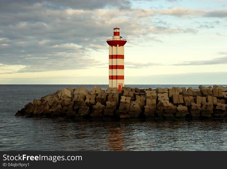 Small lighthouse maring the entrance of Praia da Vitória (Azores) harbour. Small lighthouse maring the entrance of Praia da Vitória (Azores) harbour