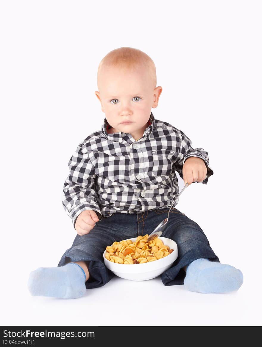 Child with a bowl of flakes on the white