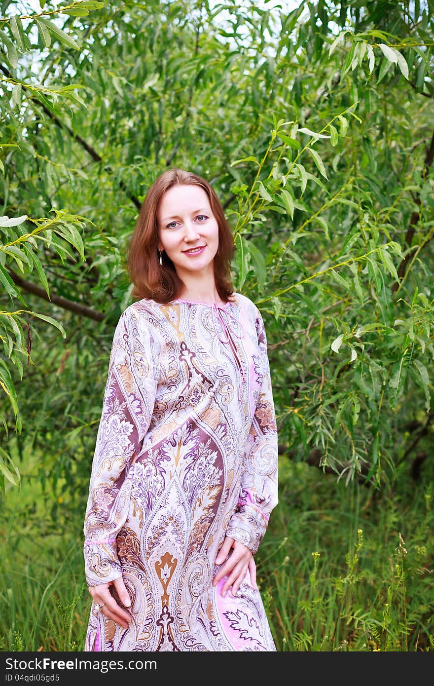 Portrait of a beautiful European woman on a background of green leaves of willow. Portrait of a beautiful European woman on a background of green leaves of willow.