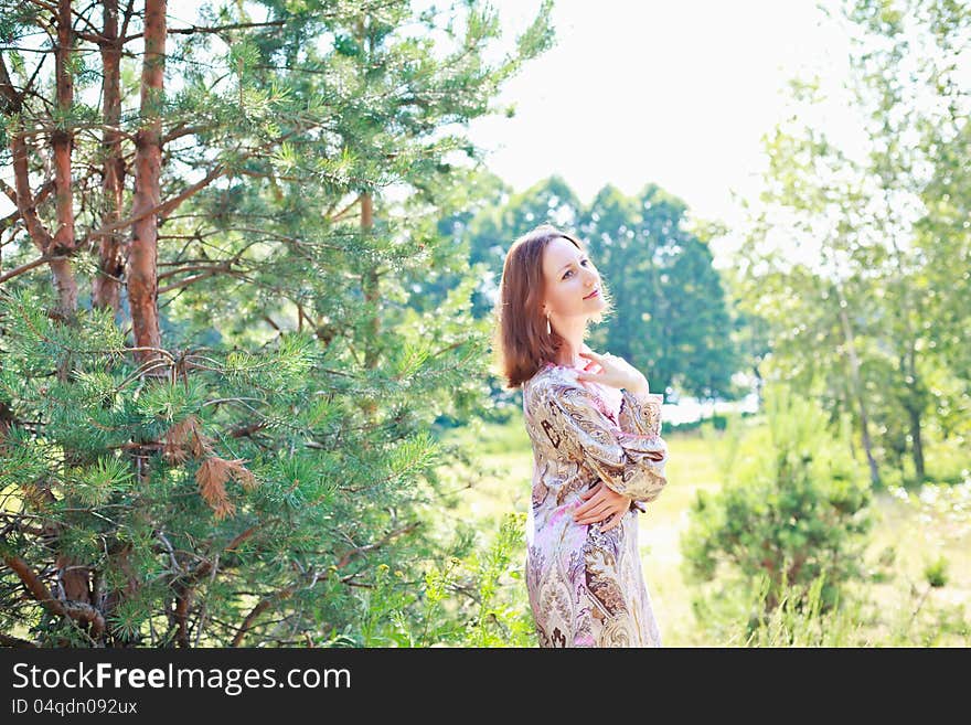 Portrait of a beautiful European woman on a background of a forest. Portrait of a beautiful European woman on a background of a forest.