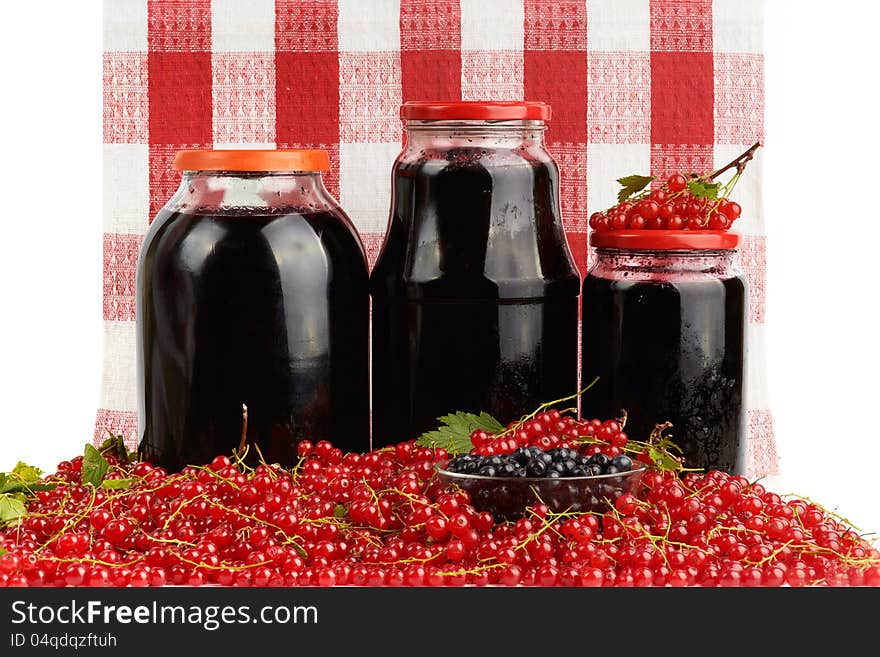 Home canning jars of berry fruits and heap of fresh red currant. Home canning jars of berry fruits and heap of fresh red currant.