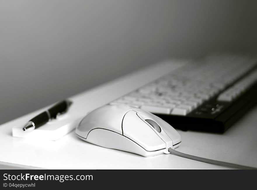 Image of a computer mouse and pen. Image of a computer mouse and pen