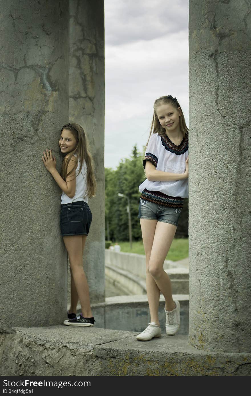 Two teenage girls playing in the park near river