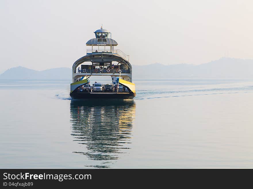 Large double-deck passenger ferry sails into the sea.