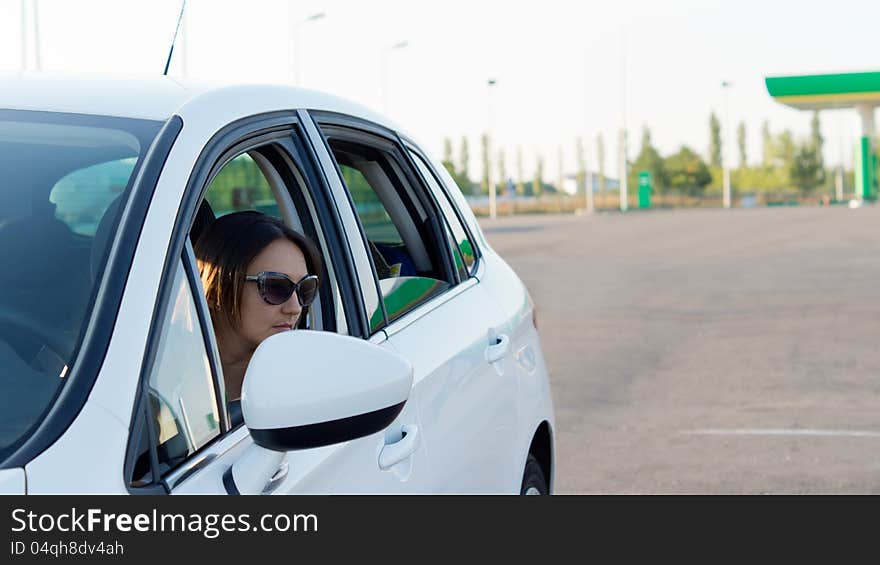 Female Driver Leaving A Gas Station