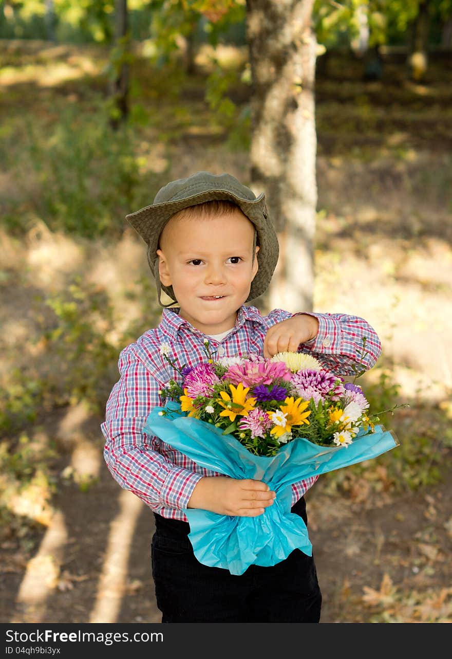 Mischievous Little Boy With Flowers