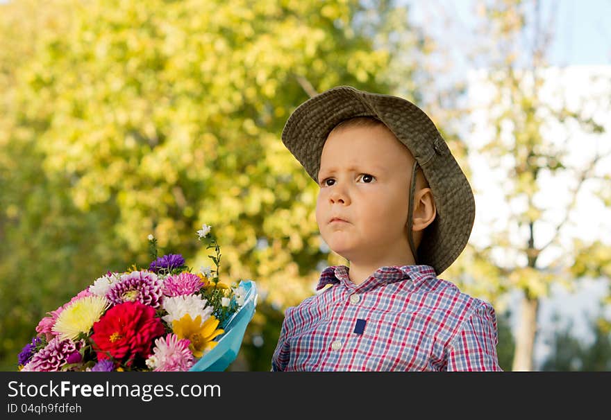 Concerned Little Boy With Flowers