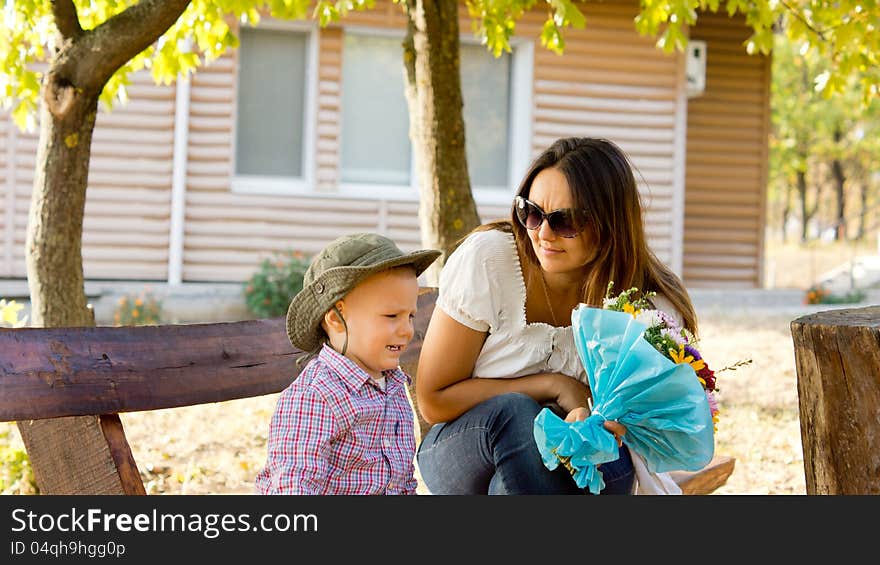 Little boy giving Mum a bouquet of flowers