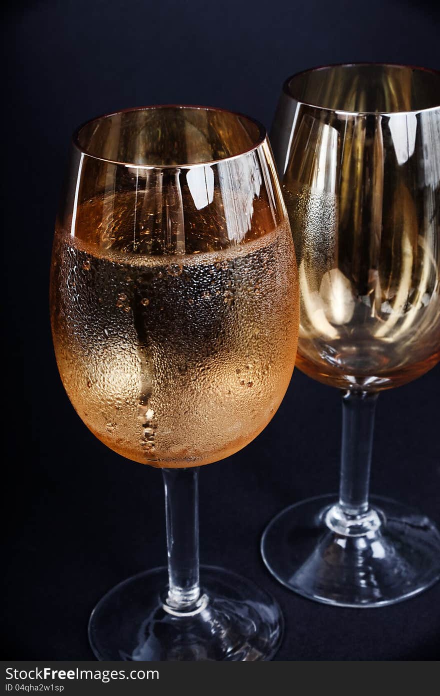 Two glasses of champagne dark background