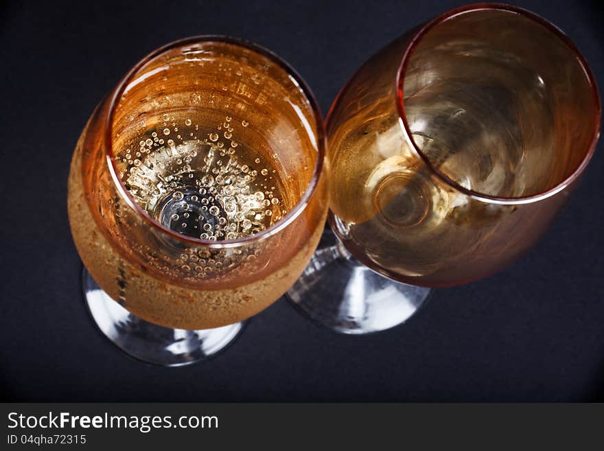 Two glasses of champagne closeup dark background