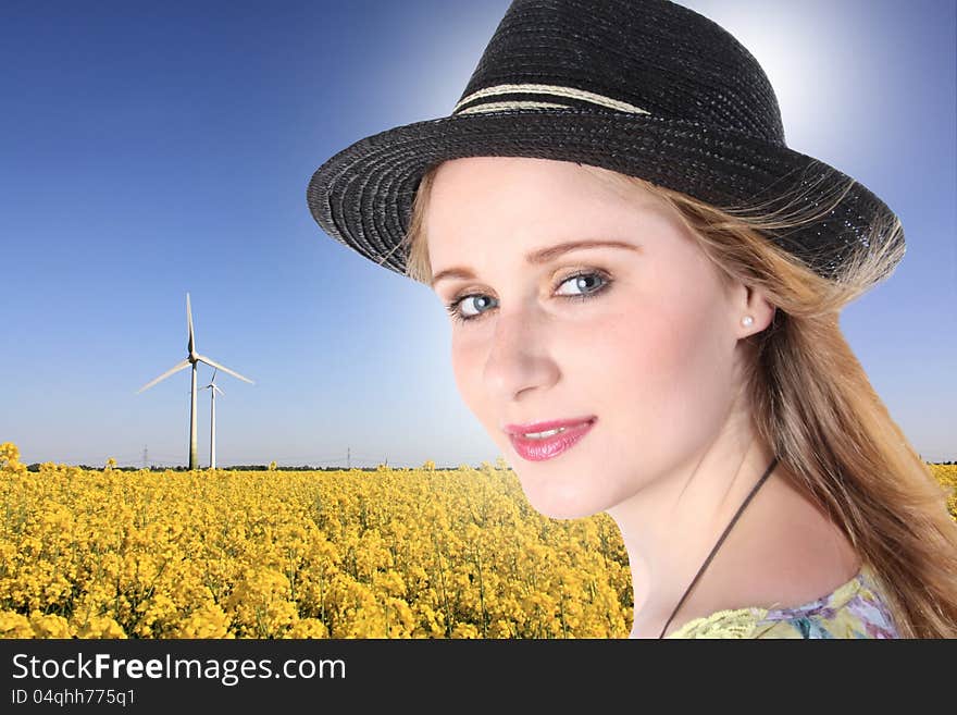 Young girl with windturbuine and field. Young girl with windturbuine and field