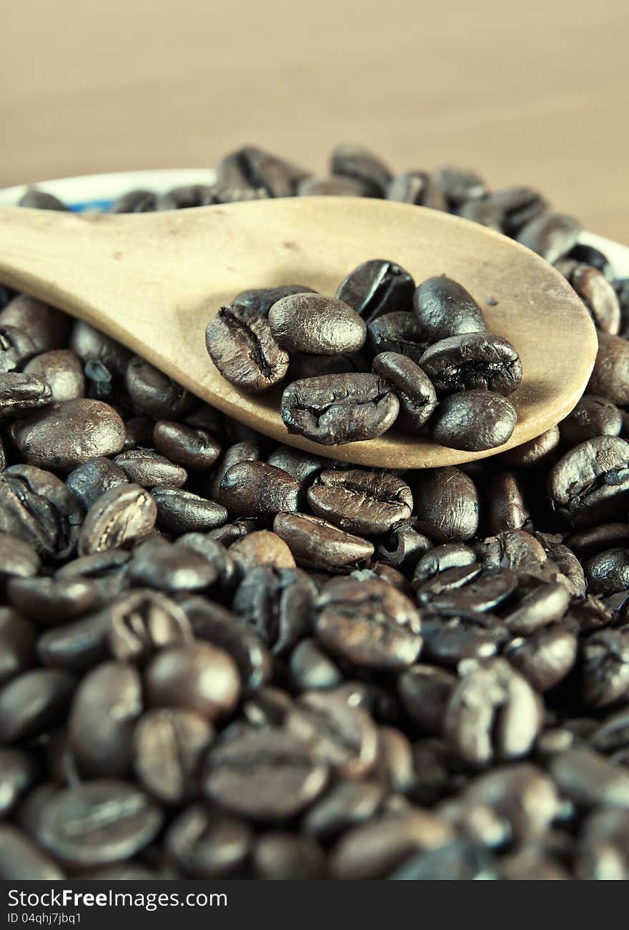 Coffee beans with wooden spoon close-up ,cross processing