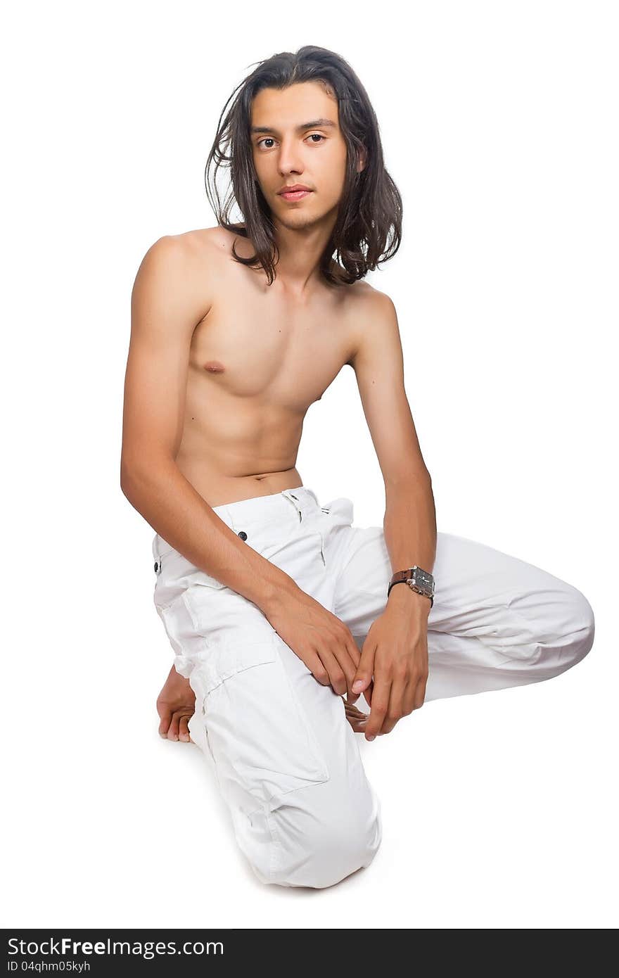 Young swarty guy in white trousers on a white background. Young swarty guy in white trousers on a white background