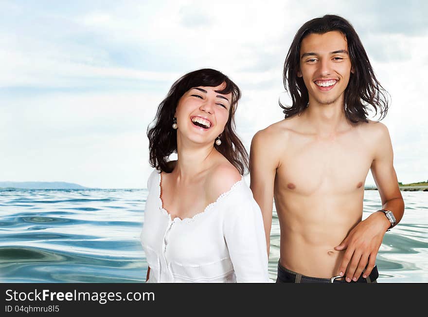 Happy young couple on the sea