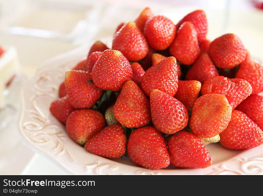 Strawberries serving on white plate. Strawberries serving on white plate