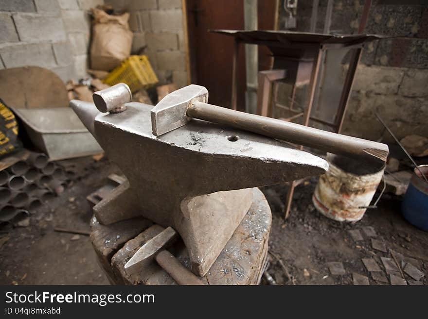 Anvil and hammer in work place