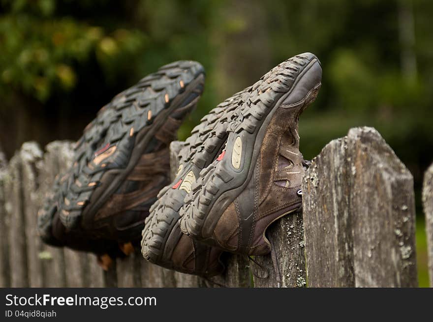 Hiking Shoes On A Fence