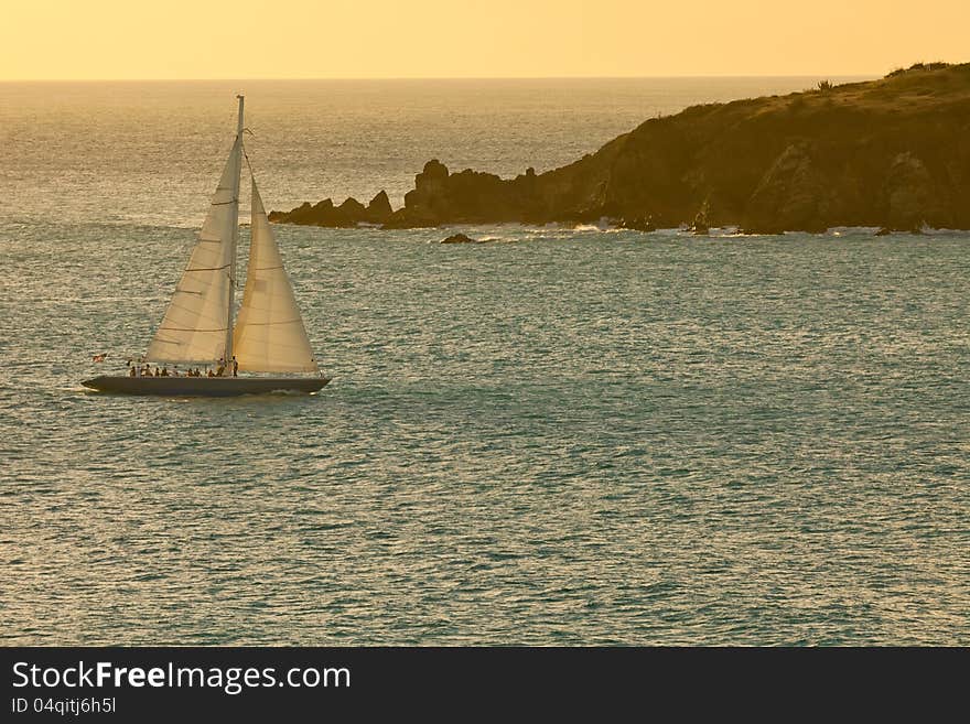 Beautiful sailboat on the Caribbean Sea as it heads into sunset. Beautiful sailboat on the Caribbean Sea as it heads into sunset.