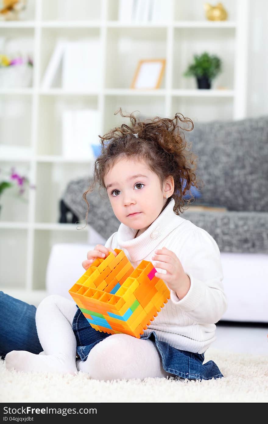 Little girl  playing with blocks at home. Little girl  playing with blocks at home