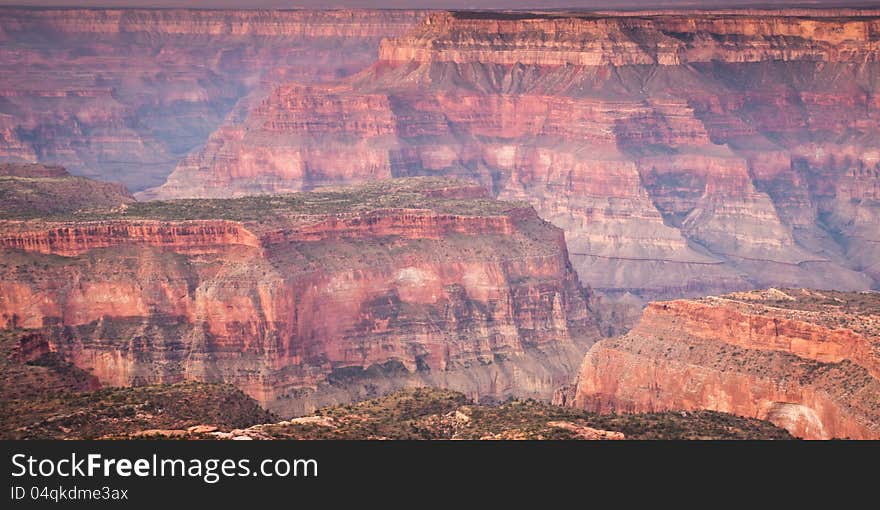 Several layers of canoyns stretch into the distance. Each layer of rock exposed displaying various colors. Several layers of canoyns stretch into the distance. Each layer of rock exposed displaying various colors.