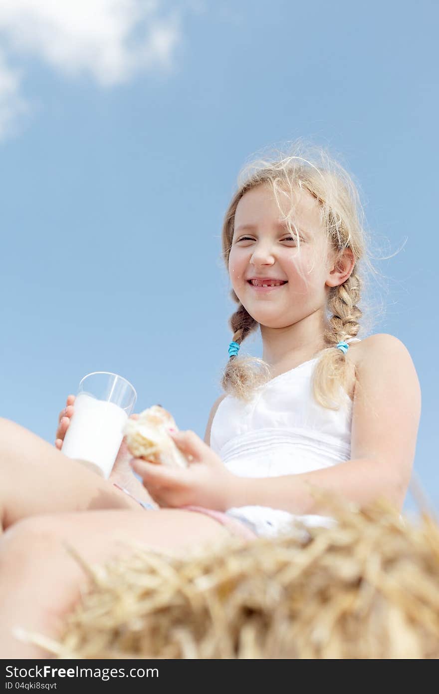 Happy blond girl eating