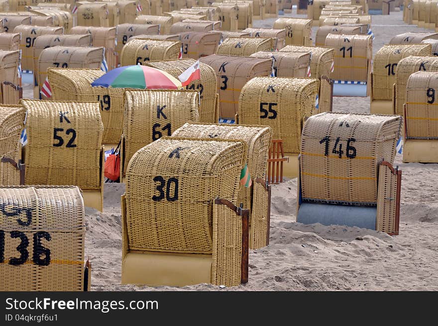 Many roofed wicker beach chairs with Umbrella