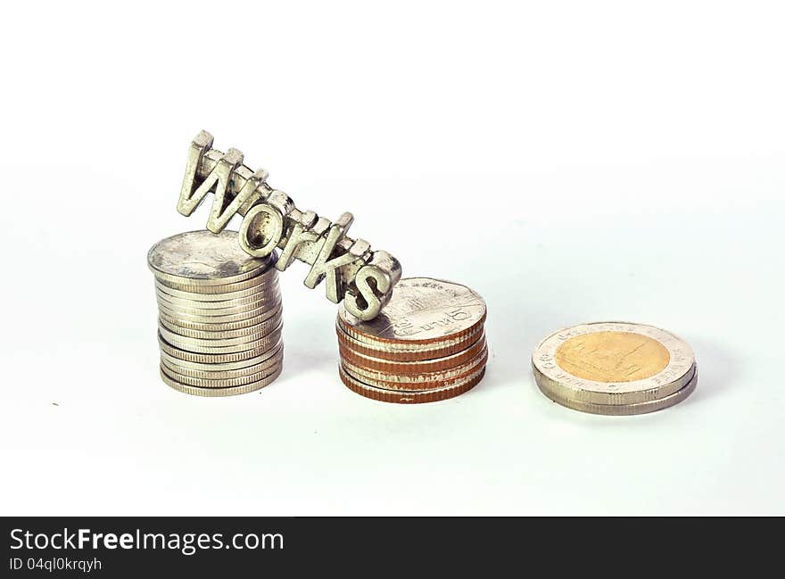 Words of works steel letter climbs on stack of coins isolated. Words of works steel letter climbs on stack of coins isolated