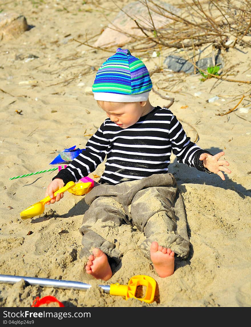 Cute Boy Playing On A Beach