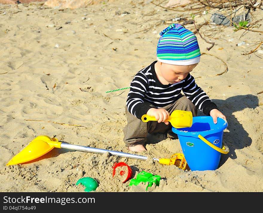 Cute Boy Playing On A Beach