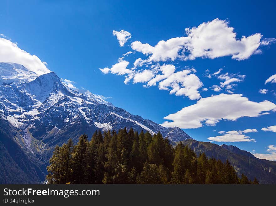 Snow Covered Mountains And Rocky Peaks In The Alps