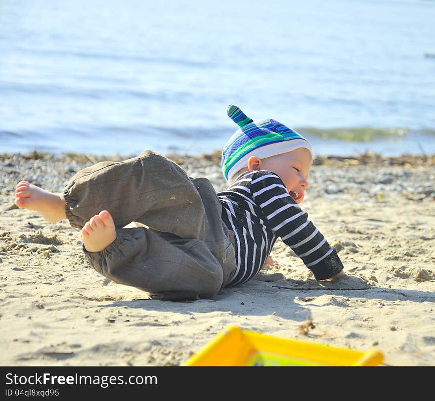 Cute Boy Playing On A Beach